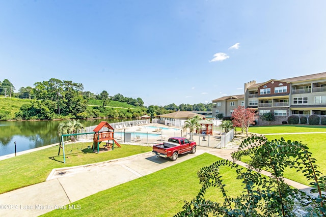 189 Williams Rd Unit E2, Alexander City, AL 35010 - view of front of property with a community pool, a water view, and a front yard
