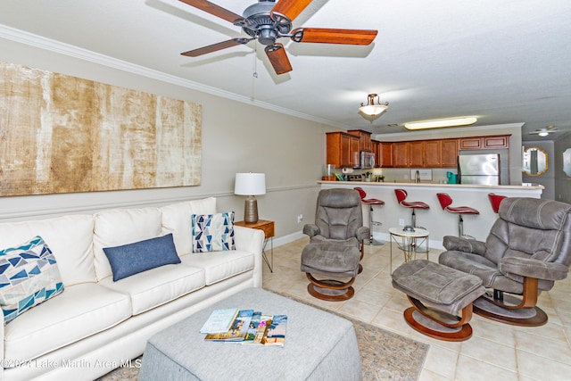 living room featuring ceiling fan, light tile patterned flooring, and ornamental molding