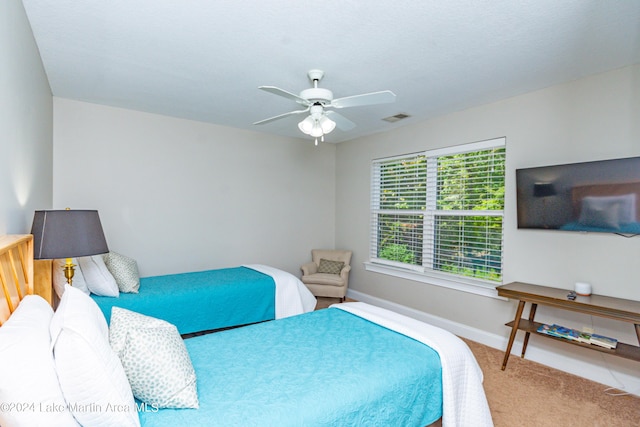 bedroom with ceiling fan and carpet