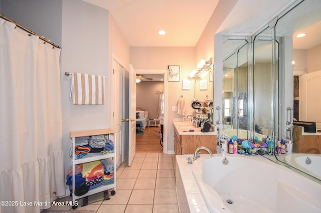 full bath featuring tile patterned flooring, a garden tub, vanity, and ensuite bath