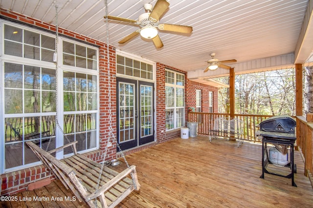 wooden deck featuring grilling area and a ceiling fan