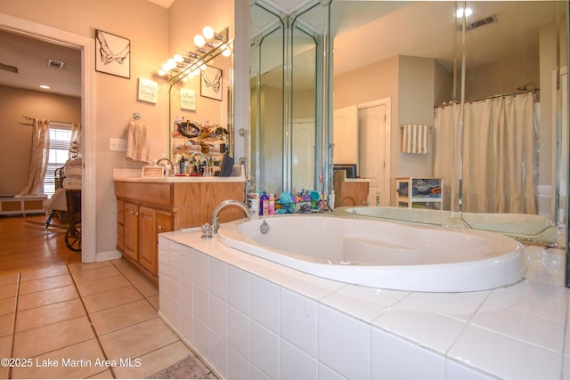bathroom with tile patterned flooring, visible vents, a bath, and vanity