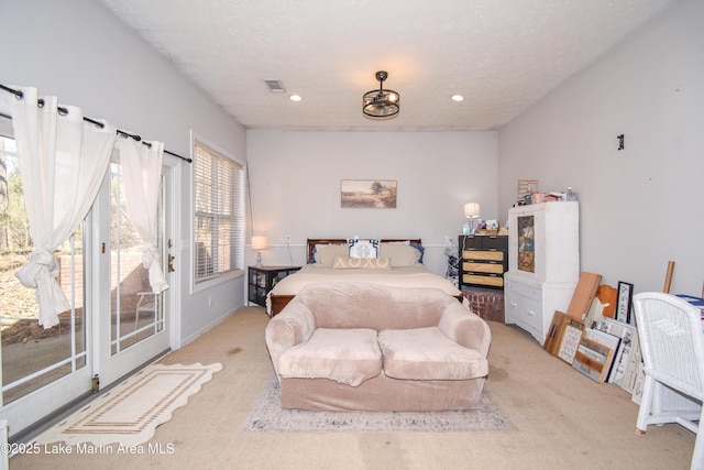 bedroom with visible vents, a textured ceiling, recessed lighting, carpet, and access to exterior