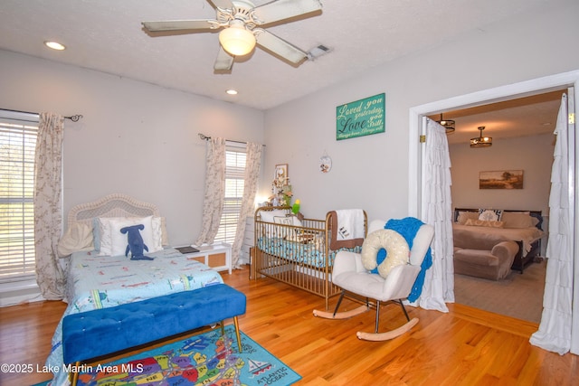 bedroom featuring recessed lighting, wood finished floors, and ceiling fan