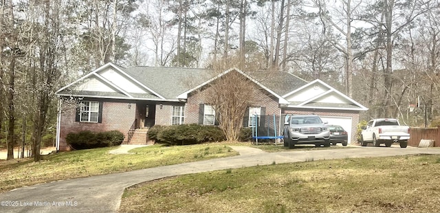 ranch-style home featuring a front yard, concrete driveway, and brick siding