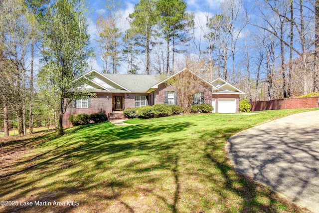 view of front of property with brick siding, a front lawn, a garage, and fence