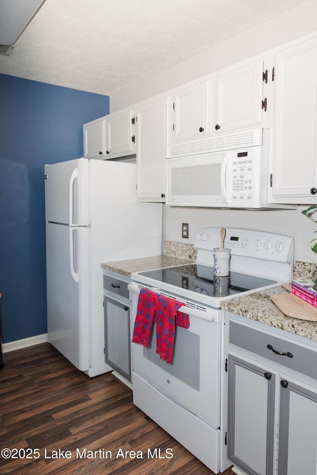 963 Birch Ct, Auburn, AL 36830 - kitchen with white appliances, dark wood-type flooring, white cabinets, and light stone countertops