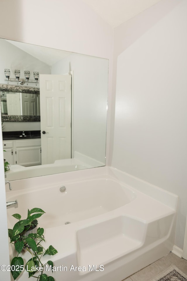 963 Birch Ct, Auburn, AL 36830 - full bathroom with tile patterned flooring, a garden tub, and vanity