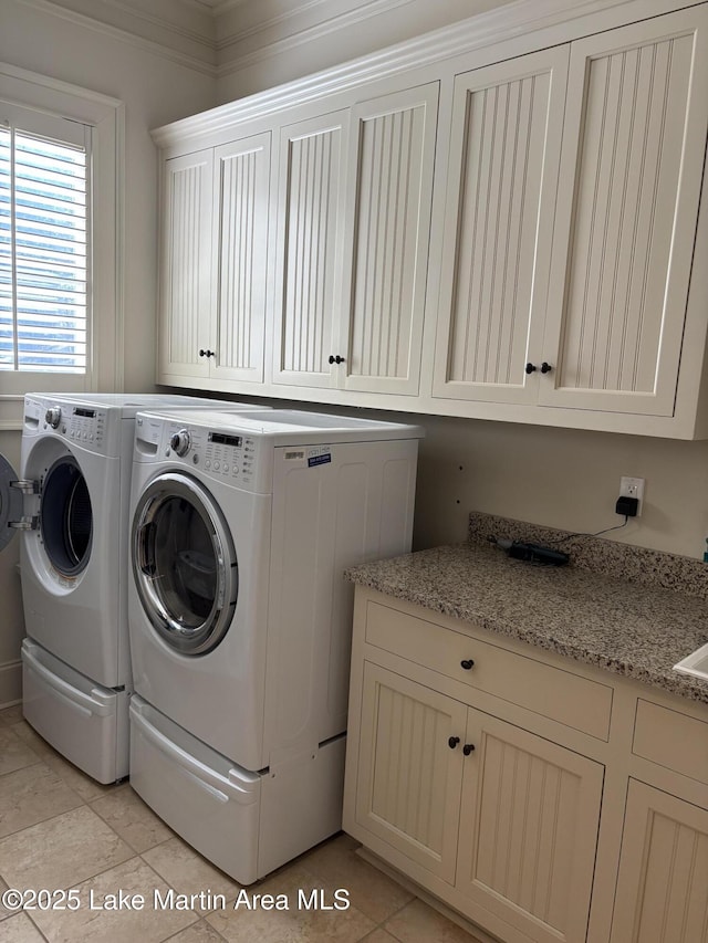 856 Windermere W Pkwy, Alexander City, AL 35010 - laundry room with cabinet space, independent washer and dryer, light tile patterned floors, and crown molding
