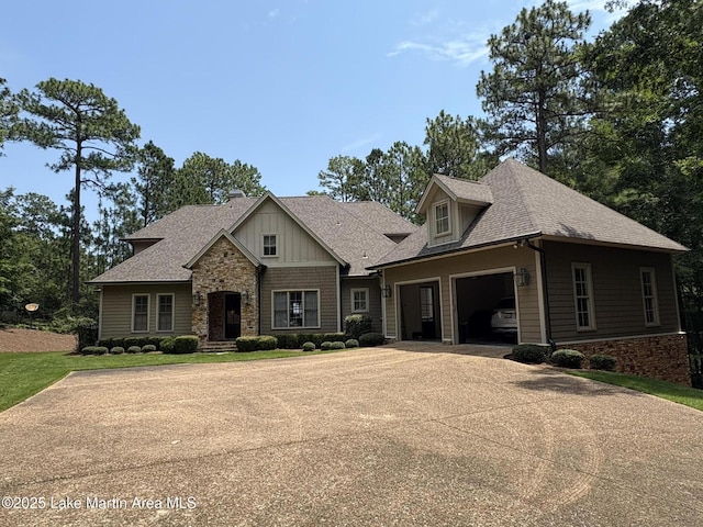 856 Windermere W Pkwy, Alexander City, AL 35010 - view of front of house with stone siding, concrete driveway, a shingled roof, and an attached garage
