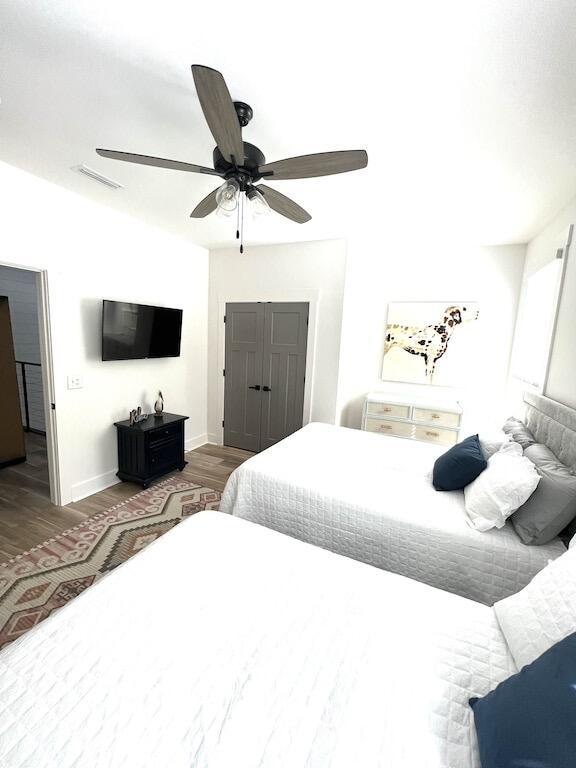 bedroom featuring ceiling fan and dark hardwood / wood-style flooring