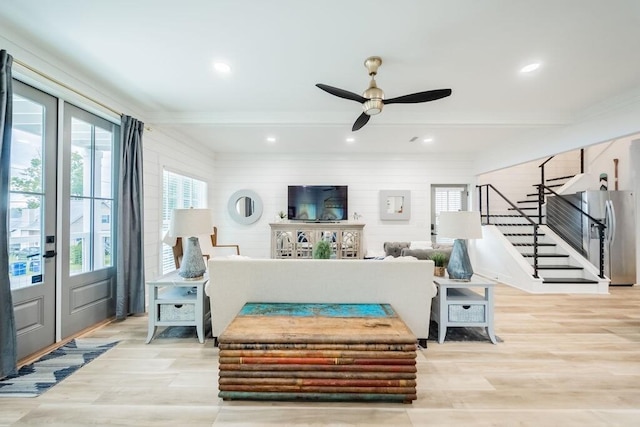 living room with french doors, light hardwood / wood-style flooring, and ceiling fan