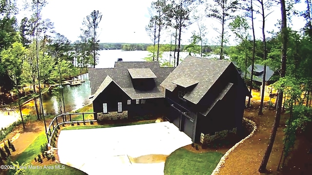 view of front facade featuring a garage and a water view