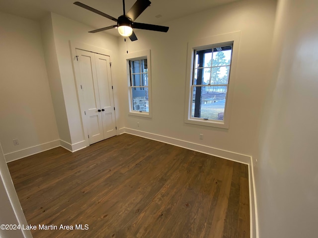 unfurnished bedroom featuring dark wood-type flooring and a closet