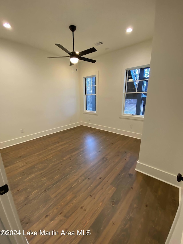 spare room featuring ceiling fan and dark hardwood / wood-style flooring