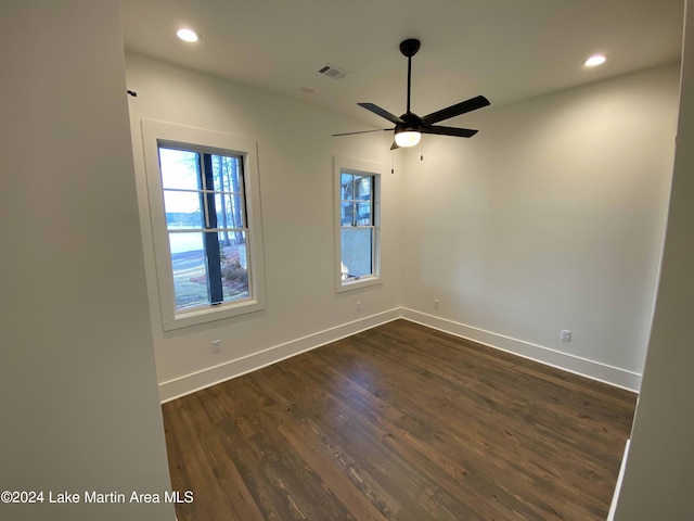 unfurnished room featuring dark hardwood / wood-style floors and ceiling fan