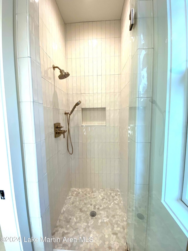 bathroom featuring a shower with door