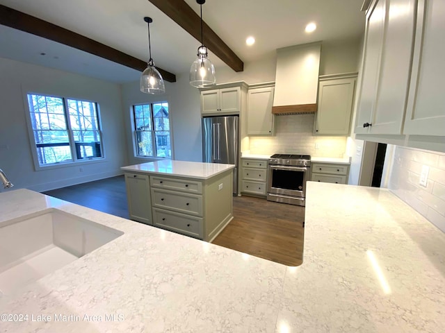 kitchen featuring pendant lighting, sink, stainless steel appliances, light stone countertops, and custom range hood