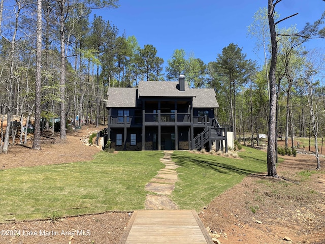 rear view of property with a yard and a deck