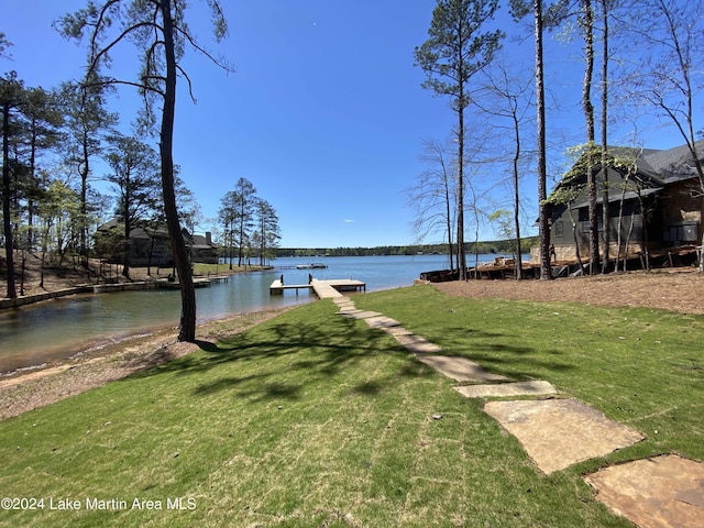 view of yard featuring a water view and a boat dock