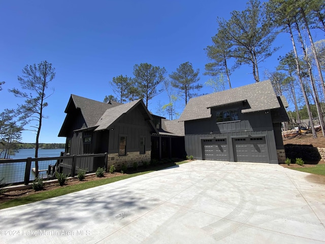 view of front facade with a garage and a water view