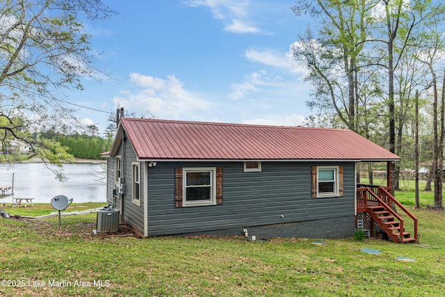 149 Lake Ridge Dr, Jacksons Gap, AL 36861 - exterior space featuring central air condition unit, stairs, a water view, metal roof, and a lawn
