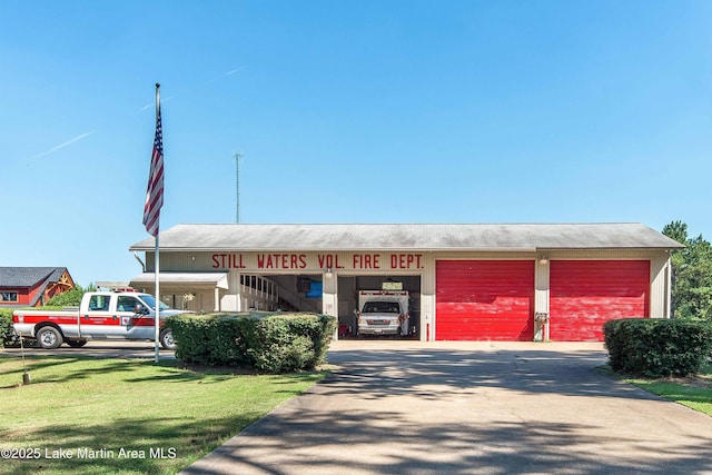 view of building exterior featuring a garage and driveway