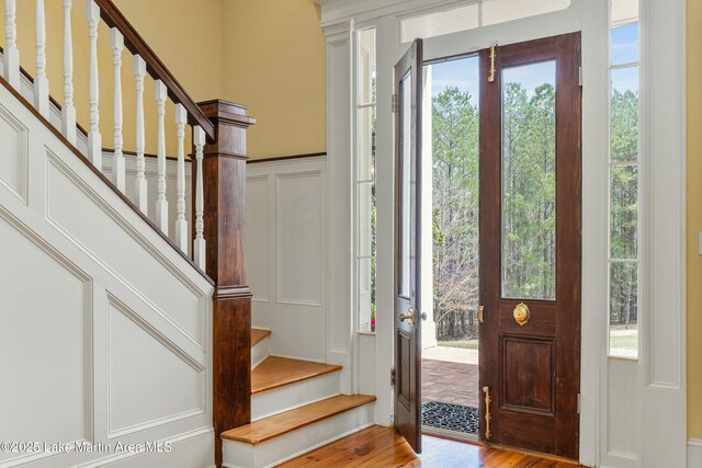 476 Pear Tree Rd, Auburn, AL 36830 - entrance foyer with a decorative wall, healthy amount of natural light, wood finished floors, and stairway