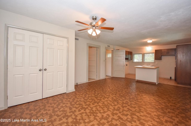 1330 Pearson Chapel Rd, Alexander City, AL 35010 - unfurnished living room featuring a ceiling fan and a sink