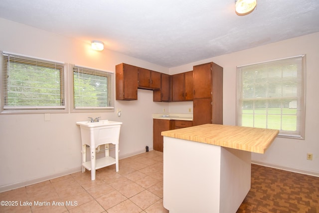 1330 Pearson Chapel Rd, Alexander City, AL 35010 - kitchen featuring brown cabinets, light tile patterned floors, and a center island