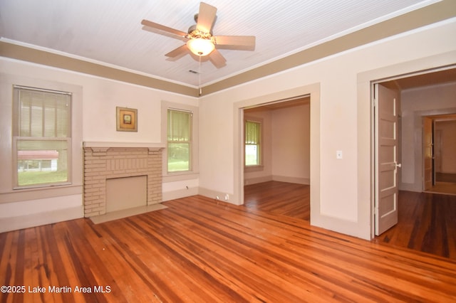 1330 Pearson Chapel Rd, Alexander City, AL 35010 - unfurnished living room with wood finished floors, ceiling fan, crown molding, and a brick fireplace