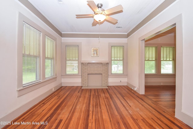 1330 Pearson Chapel Rd, Alexander City, AL 35010 - unfurnished living room featuring wood-type flooring, crown molding, ceiling fan, and a brick fireplace