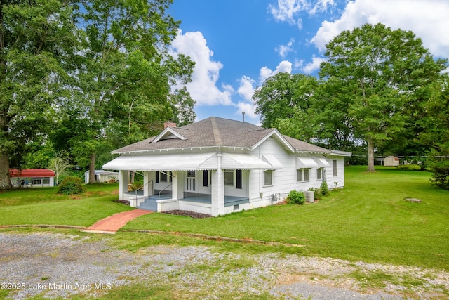 1330 Pearson Chapel Rd, Alexander City, AL 35010 - back of property with covered porch, a lawn, a chimney, and roof with shingles