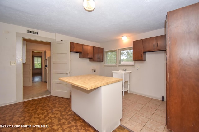 1330 Pearson Chapel Rd, Alexander City, AL 35010 - kitchen featuring a textured ceiling and butcher block counters
