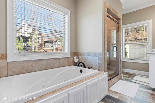 full bath with a stall shower, a jetted tub, and plenty of natural light