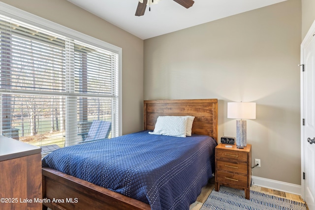 bedroom with ceiling fan and light hardwood / wood-style floors