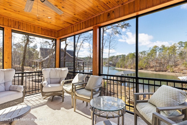 sunroom / solarium with ceiling fan, a water view, and wooden ceiling