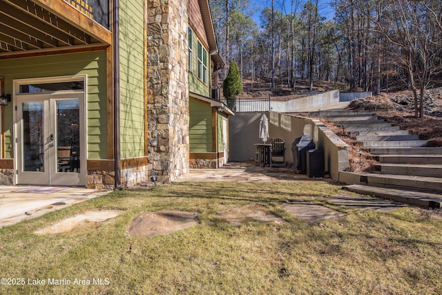 view of yard with a patio and french doors