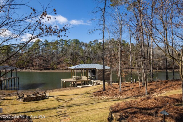 dock area with a water view and an outdoor fire pit