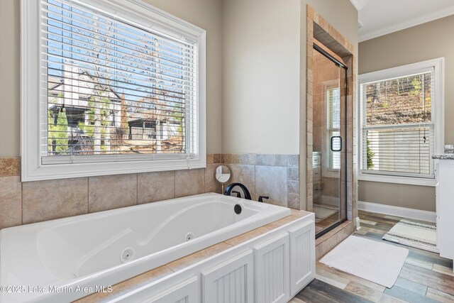 bathroom featuring separate shower and tub, wood-type flooring, and ornamental molding