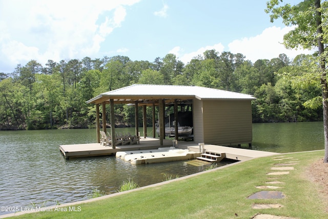 view of dock with a forest view and a water view