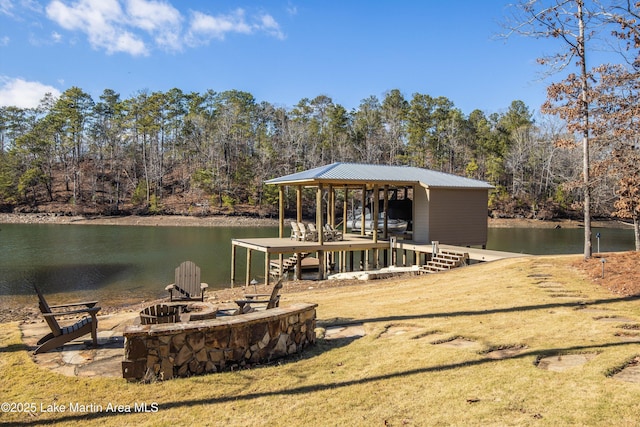 dock area with a water view and a fire pit