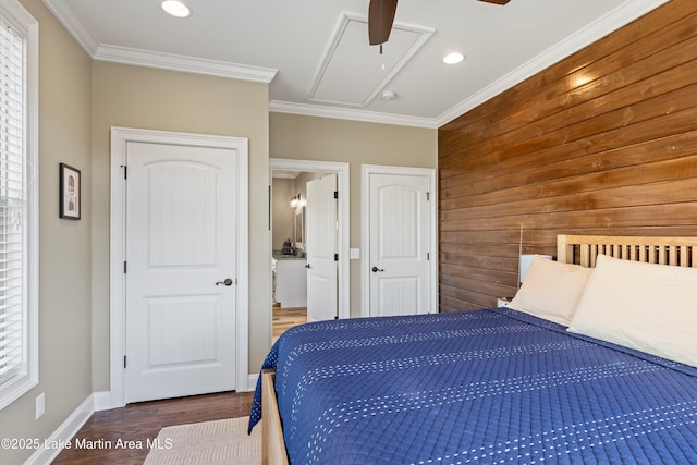 bedroom featuring dark wood-type flooring, ceiling fan, wooden walls, and crown molding