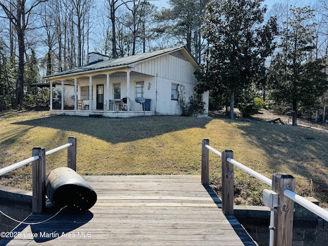 exterior space featuring concrete block siding and a lawn