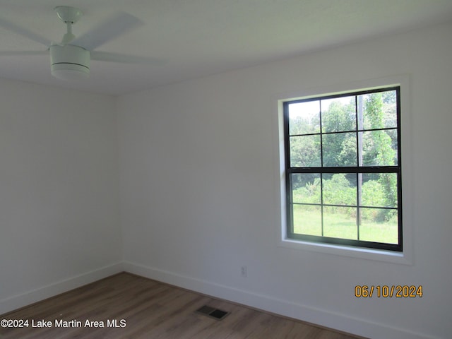 unfurnished room with hardwood / wood-style floors