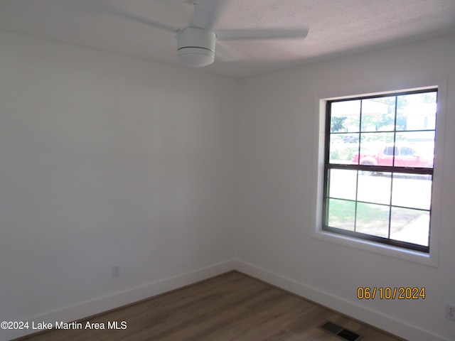 empty room featuring hardwood / wood-style flooring and ceiling fan