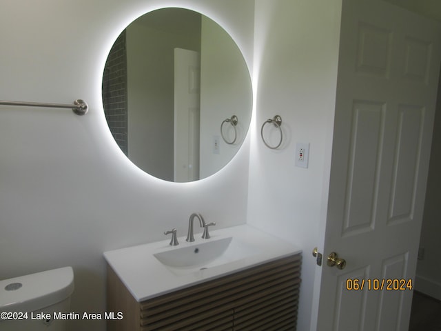 bathroom featuring vanity and toilet