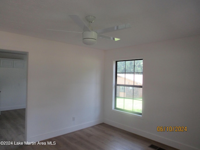 empty room with hardwood / wood-style floors and ceiling fan