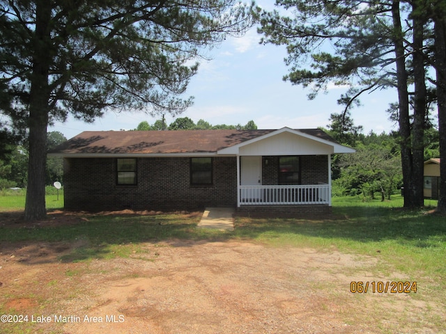 ranch-style home with a porch and a front yard