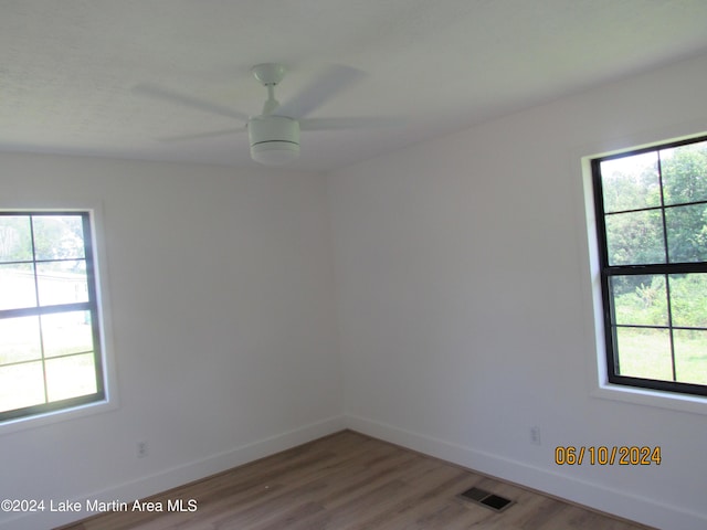 empty room featuring hardwood / wood-style flooring and ceiling fan